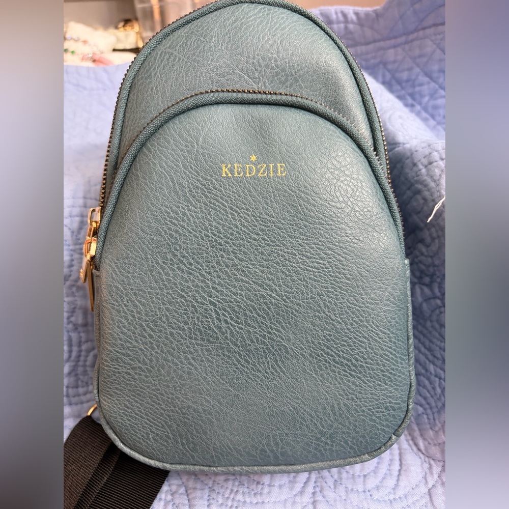 Kedzie Sunset Sling Crossbody for Women Teal in color